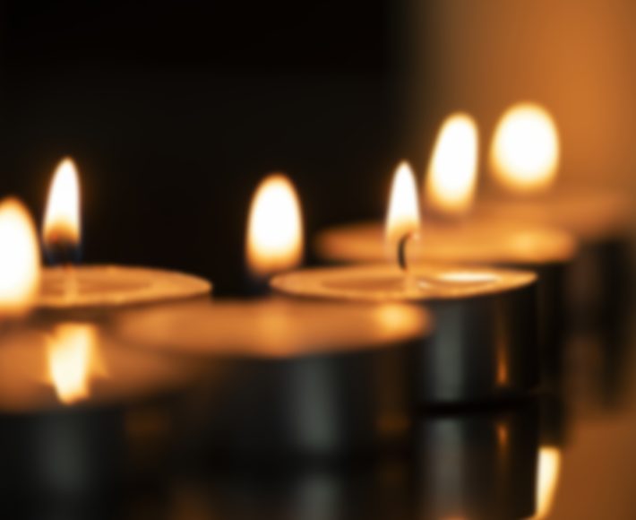Sad, funeral and flowers with couple and coffin in church for death, respect and mourning. Grief, goodbye and empathy with man and woman loss at casket with depression, remember and farewell memorial.